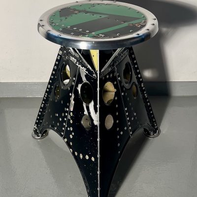 Das Projekt Aero 1946 kombiniert die Handwerksarbeit nach dem klassischen Flugzeugbau der 1940er Jahre mit dem Prinzip des Upcyclings. Das Material stammt in der Regel von Heckauslegern, Finne oder Elevatoren alter BELL-Hubschrauber. Die ultraleichten Hocker sind stylische Unikate und sehr belastbar. Die unterschiedlichen Farben, Beschriftungen und Nietlöcher verweisen auf die ursprüngliche Verwendung. Jeder Hocker ist auf der Unterseite mit dem passenden Typenschild versehen.